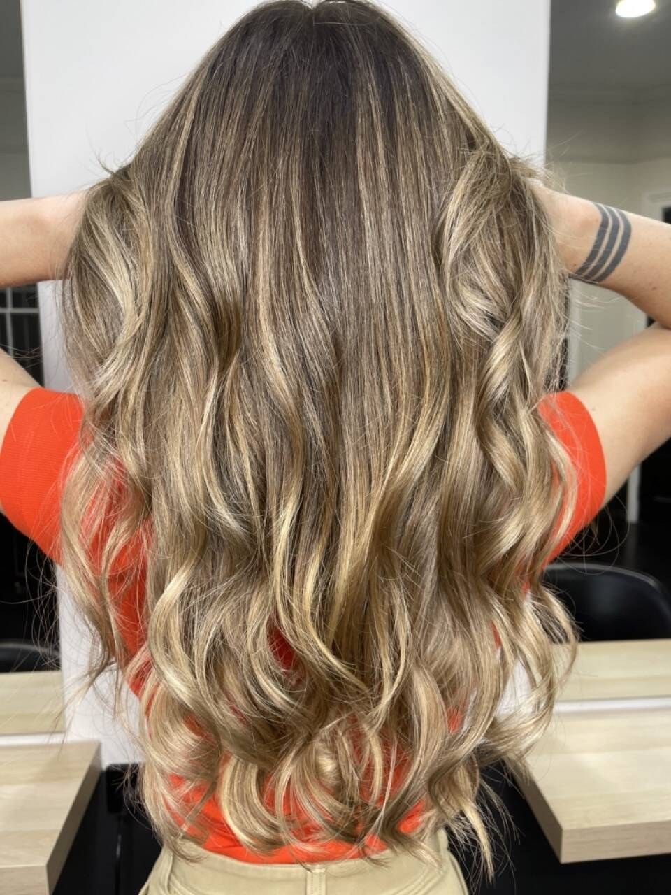 Bronde balayage with warm blonde highlights through long waves