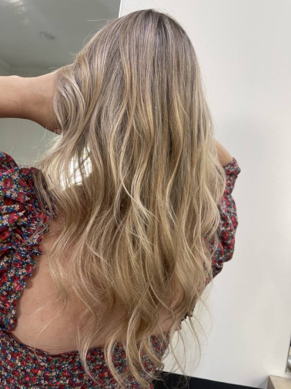 Long, soft lived-in blonde balayage with a natural root