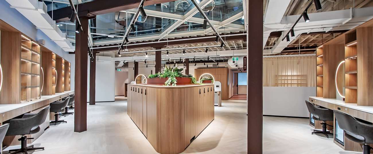 Inside the Teneriffe co-working space where Tara works: warm timber joinery, ring-lit mirrors, skylights and a calm open floor