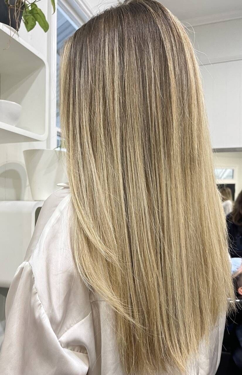 Straight blonde balayage with a soft rooted blend