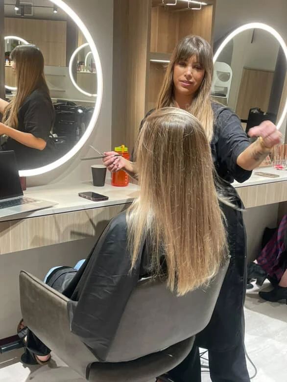Tara Quin styling a client's long blonde balayage at her chair in Teneriffe